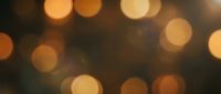 Warm golden bokeh lights creating dreamy atmosphere with soft circular light spots on dark background for festive celebrations and romantic occasions.