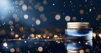 Glowing glass jar with magical sparkles and bokeh lights against dark blue background creates dreamy atmospheric composition for holiday designs.
