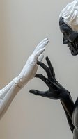 White and black robotic hands reaching towards each other against neutral background, representing artificial intelligence and technological connection.