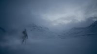 Solitary figure standing in snowy mountain landscape during blizzard with heavy fog and overcast sky, conveying isolation and survival in harsh winter conditions.