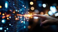 Hand touching digital data stream with glowing particles and bokeh lights representing technology innovation and connectivity in modern business environment.