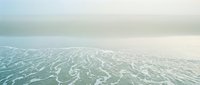 Serene turquoise ocean water with gentle waves under soft cloudy sky creating peaceful seascape for relaxation and meditation backgrounds.