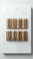 Wooden clothespins arranged in neat rows on white marble surface for laundry organization and household storage solutions.