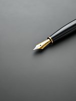 Elegant fountain pen nib with gold-plated details on dark gray background, close-up view showing fine craftsmanship and writing precision.