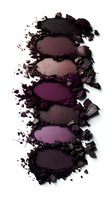 Crushed purple and plum eyeshadow palette swatches with scattered powder texture on white background, isolated for beauty and cosmetic marketing.