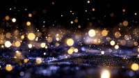 Magical glowing bokeh lights on dark background with sparkles and blurred golden particles create dreamy atmospheric effect for festive designs.