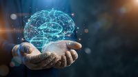 Digital brain hologram floating above open hands with glowing neural network connections representing artificial intelligence and machine learning technology.