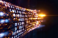 Binary code streaming with glowing light effects and motion blur creates dynamic digital data visualization against dark background. Technology concept.