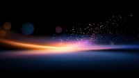 Glowing light trail with colorful bokeh particles and sparkles against dark background creates magical atmospheric effect for festive designs and celebrations.