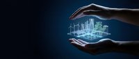 Hands holding glowing holographic smart city infrastructure with wind turbines and buildings, representing sustainable urban development and future technology innovation.