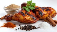 Grilled chicken with spices and herbs on white background, surrounded by cinnamon sticks, salt, pepper, paprika powder and fresh cilantro garnish.