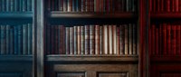 Vintage wooden bookshelf filled with antique leather-bound books in dark tones, evoking classic library atmosphere for education and literature themes.