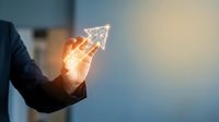 Businessman hand holding glowing upward arrow symbol representing growth, success, and rising profits for business strategy and financial performance concepts.
