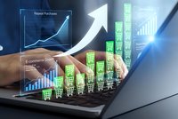 E-commerce growth analytics with shopping cart icons and upward trending graphs on laptop screen showing business success metrics and sales performance data.
