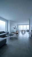 Spacious modern apartment interior with minimalist design, concrete flooring, floor-to-ceiling windows, gray seating, and contemporary furniture for residential or commercial use.