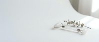 Elegant silver stud earrings with geometric design on white surface, minimalist jewelry accessories for fashion and style photography.