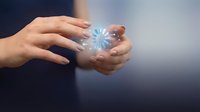 Hands holding glowing blue snowflake symbol representing winter, cold season, frozen weather, and seasonal concepts for design and marketing projects.