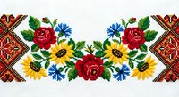 Traditional Ukrainian embroidery pattern with sunflowers, roses and cornflowers on white fabric. Folk art design for textile decoration and cultural crafts.