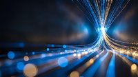 Abstract fiber optic light trails with glowing bokeh effects creating dynamic energy flow on dark background for technology and communication concepts.