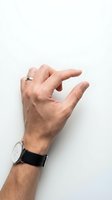 Male hand with wedding ring and wristwatch making pinching gesture against white background. Isolated for design use on marketing materials, websites, and presentations.