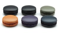 Colorful French macarons collection isolated on white background featuring assorted flavors in dark and pastel colors for bakery menu design.