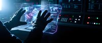 Futuristic holographic interface with hands manipulating transparent digital displays in high-tech control room environment for advanced technology applications.