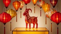 Red paper-cut goat silhouette with traditional Chinese patterns displayed on wooden table surrounded by colorful hanging lanterns for lunar new year celebration.
