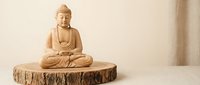 Wooden Buddha statue in meditation pose on a natural wood slice, set against a neutral beige background, evoking peace and mindfulness.