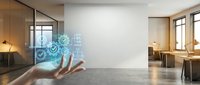 Hand displaying holographic digital interface with glowing icons in modern office workspace for technology and business innovation concepts.