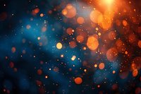 Abstract orange and blue bokeh lights with glowing particles creating magical atmosphere for festive backgrounds, celebrations, or cosmic designs.