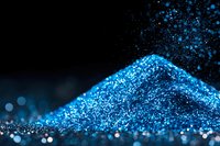 Shimmering pile of bright blue glitter powder with scattered sparkles and bokeh effect on dark background, macro photography for cosmetic and artistic designs.