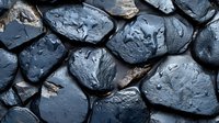 Wet black stones with water drops creating natural pattern. Dark rocks texture with glossy surface and organic shapes for spa and wellness background.