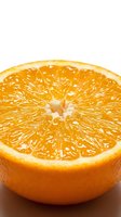 Fresh orange half cut closeup showing juicy pulp and vibrant citrus texture on white background, great for food and healthy lifestyle concepts.