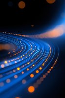 Glowing curved blue light trails with orange bokeh effects against dark background create dynamic motion and energy flow pattern for technology concepts.