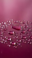 Translucent pink gel droplets and beads scattered across a magenta surface with shallow depth of field, suitable for cosmetics, skincare, and beauty product marketing.