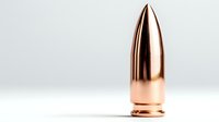 Copper-plated bullet ammunition on white background with dramatic lighting and reflection, isolated object for design and commercial use.