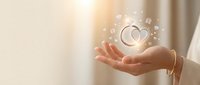 Woman's hands cupped holding glowing heart symbol with sparkles representing love, care, healthcare, wellness, charity, compassion and emotional support.