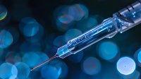 Medical syringe with needle on dark blue bokeh background, close up macro shot showing transparent glass and steel details in modern healthcare setting.
