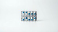 Blister pack of blue and white capsule medications isolated on white background, ready for pharmaceutical, healthcare, and medical design projects.