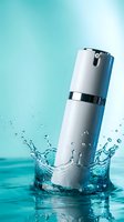 White cosmetic serum bottle with silver pump dispenser splashing into clear water against turquoise background for skincare and beauty product advertising.