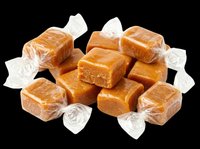 Soft caramel candies wrapped in clear cellophane, pile of golden toffee sweets isolated on transparent background, ready for stickers, t-shirt design, print on demand.