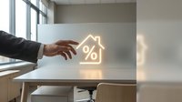 Businessman hand touching glowing neon house icon with percentage symbol on glass surface, representing mortgage rates, real estate investment, and property financing solutions.