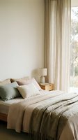 Serene bedroom interior with neutral tones, featuring a neatly made bed with layered bedding, decorative pillows, wooden nightstand with ceramic lamp, and sheer curtains filtering natural light from window.