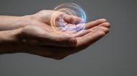 Male hands cupping glowing holographic sphere with digital rings, representing technology innovation, virtual reality, and futuristic concepts for business.