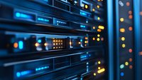 Modern server room equipment with glowing blue LED indicators and blurred lights in background, close-up view showing network infrastructure technology.