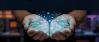 Hands holding glowing digital brain with data particles, representing artificial intelligence, technology innovation, and machine learning concepts for business solutions.