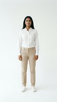 Young woman with South Asian ethnicity wearing casual business attire consisting of a white button-up shirt and beige chinos, standing against neutral background. Suitable for corporate, fashion, and lifestyle marketing.