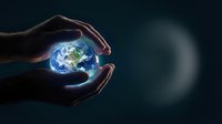 Hands gently cradling glowing Earth globe against dark background, symbolizing environmental protection, sustainability, and global responsibility for conservation efforts.
