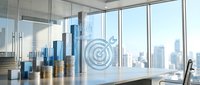 Stacked coins and target symbol on office desk with city skyline view through windows, representing financial goals and business success.