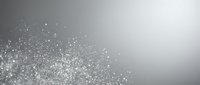 Abstract silver glitter particles floating on gradient gray background with sparkling light effects and bokeh for luxury design projects.